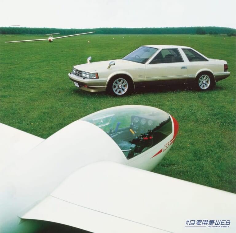 グライダーとともに写る、芝生の上に停車するトヨタ 初代ソアラ(販促用画像)|「金持ちおじに大人気だった」狙いは大成功。豪華で女性ウケも良好。バブル時代に一世を風靡したトヨタのスペシャリティクーペ