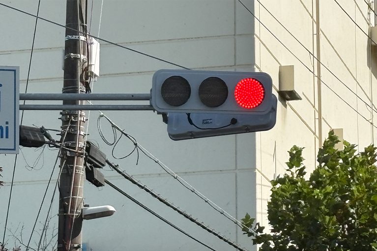 赤が点灯している、LEDタイプの信号機|信号機「黄色は真ん中、赤と青はどっちだっけ…」“色の並び”は全国共通。実はこの順番にもちゃんと理由があった! 意外と知らない信号の常識