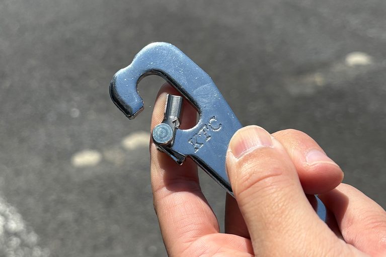 京都機械工具（KTC）のドアストッパー AP902Aを手に持っている写真｜「使ってみたら最高だった…」名門工具メーカーが作った意外なギア。ドアストライカーに装着するだけでOK！ 車内換気にも使える［KTC・ドアストッパー AP902A］